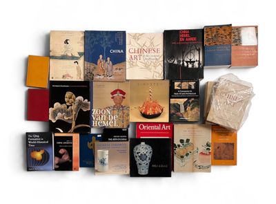 a lot of books that are on a white surface