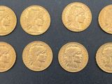 a close up of a bunch of gold coins on a black surface
