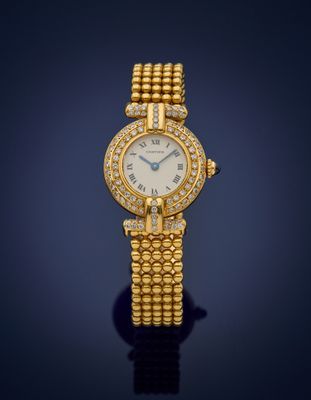a lady ' s gold and diamond wrist watch