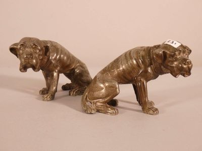 pair of bronze figurines of two dogs with tags on their ears