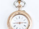 a gold pocket watch with roman numerals on it