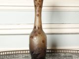 a vase sitting on a table with a marble top