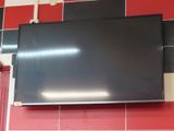 a flat screen tv mounted on the wall in a kitchen