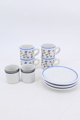 a white table with blue and white plates and cups on it
