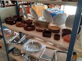 a shelf with a lot of dishes and pans on it