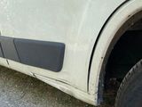 a car that has been damaged and is parked on the side of the road