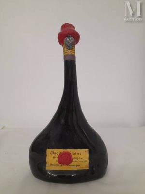 a black bottle with a red cap on top of it