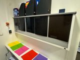 a desk with a computer monitor and a printer on top of it