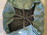 a bag with a bunch of grass in it on the floor