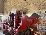 a red machine that is sitting inside of a building