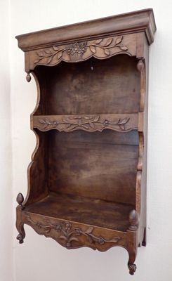 a wooden shelf that has a shelf on it