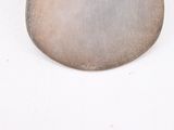 a picture of a metal object on a white surface