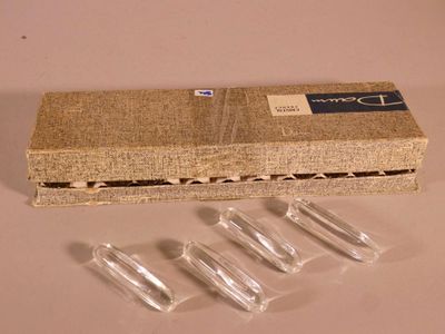 a box of clear plastic pieces on a table