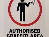 a sign that says authorized graffiti area on the wall