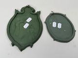two green plates with tags on them sitting on a table