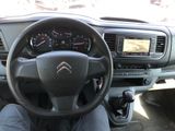 the interior of a car with a steering wheel and dashboard controls