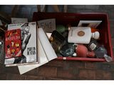 a red box filled with assorted items on the floor