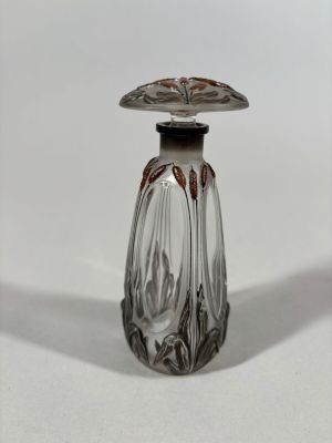 a small glass bottle with a lid on a white surface