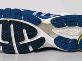 the sole of a blue and white running shoe on a white surface
