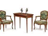 two chairs and a table with a bird figurine on top of it
