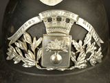 a metal helmet with a crown and a ribbon on it