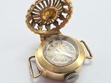 an image of a gold pocket watch on a white surface