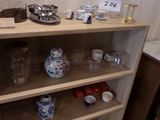 a shelf with cups and bowls on it in a kitchen