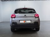 the rear end of a silver citrole parked in a garage