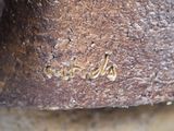 a close up of a piece of metal with writing on it