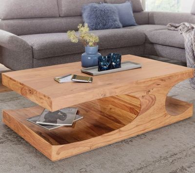 a coffee table with a magazine on it in a living room