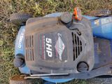 a lawn mower that is sitting on the grass