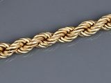 an image of a close up of a gold chain on a table