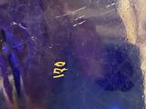 a close up of a glass vase with a blue vase in it