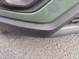 a close up of the front bumper of a green car
