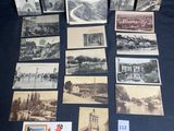 an assortment of old postcards and postcards on a table