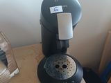 a coffee maker sitting on top of a wooden table