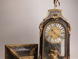 a clock and a box sitting next to each other