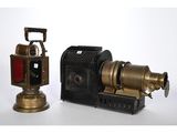 two antique cameras sitting next to each other on a white surface