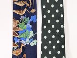 two neck ties with birds and flowers on them on a white background