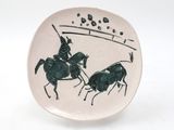 a plate with a picture of two men on horses