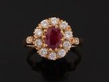 an oval ruby and diamond cluster ring