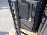 an image of a black stove on a pallet in a parking lot