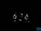 two pieces of clear crystal sitting on top of a black surface