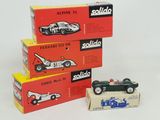 three boxed boxes of model cars sitting on top of each other
