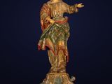 a wooden statue of a woman holding a child