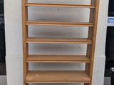 a tall wooden shelf with a lot of shelves on it