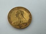 a gold coin with a woman ' s profile on it