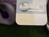 a purple bicycle that has a tag on it