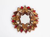 a picture of a decorative mirror on a white wall