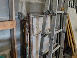 several pieces of metal are stacked up against a wall